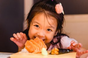 Child eating fish